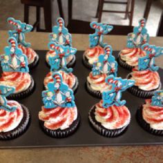 cupcakes decorated with red, white and blue frosting are on a black tray