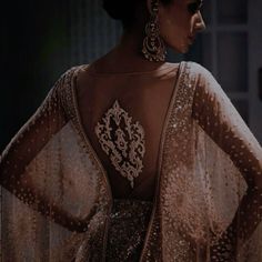 the back of a woman's dress with sequins and jewels on it