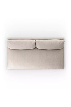 an upholstered couch with two pillows on it's back and one arm