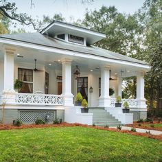 a white house with porches and columns