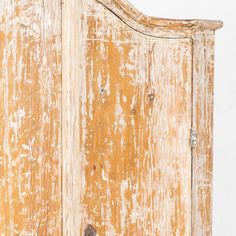 an old wooden armoire with peeling paint on it