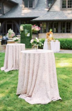 a table with flowers on it in front of a house