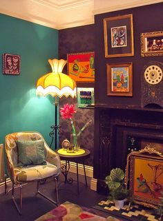 a living room filled with furniture and pictures on the wall next to a fire place