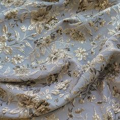 the fabric has gold flowers on it and is very light blue with brown trims