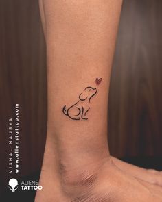 a small dog with a heart tattoo on the ankle