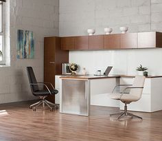 an office with a desk, chair and laptop on the table in front of a window