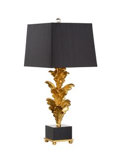 a table lamp with a black shade on the top and gold leaf decorations on the base