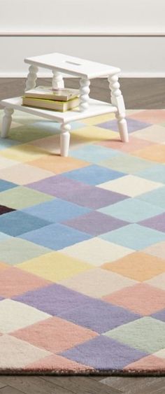 a multicolored rug with a white bench in the middle