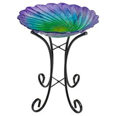 a glass flower sitting on top of a metal stand