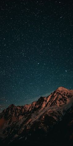 the night sky is filled with stars above mountains