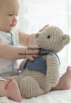 a baby is playing with a stuffed animal