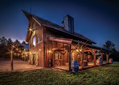 an old wooden building with lights on it