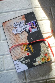 a happy birthday card with the number twenty one on it and some pictures attached to it