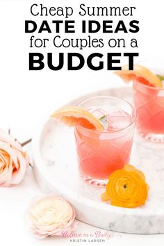 two glasses filled with watermelon and orange juice on top of a marble tray