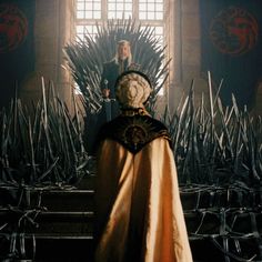 a woman standing on top of a iron throne in the middle of a game of thrones