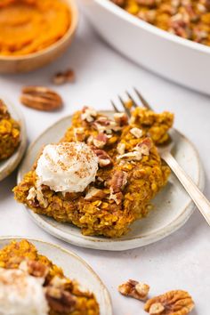 two plates with desserts on them sitting on a table next to bowls of mashed sweet potatoes