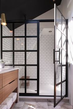 a bathroom with black and white tiles on the walls