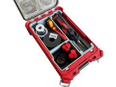 a red tool box filled with tools on top of a white surface