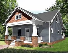 a small gray house with porches on the front