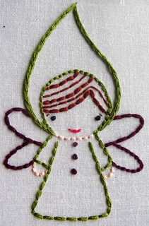 an embroideryed angel with red hair and pink eyes on a white background, surrounded by green thread