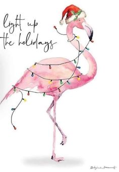 a pink flamingo wearing a santa hat and lights