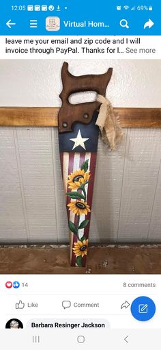 an ironing board with sunflowers on it next to a wooden sign that says,