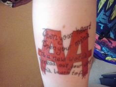 a woman's leg with the word love written in red ink on her arm