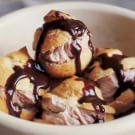 a white bowl filled with chocolate covered pastries