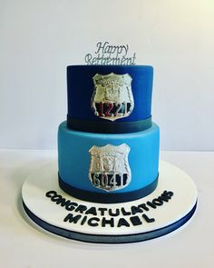 a three tiered cake decorated with the emblem of two different departmentss on it