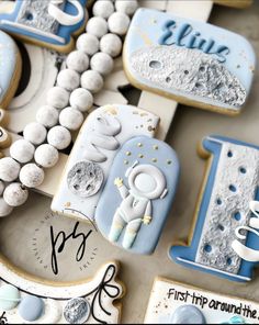 decorated cookies are arranged in the shape of letters and numbers, including one with an astronaut on it