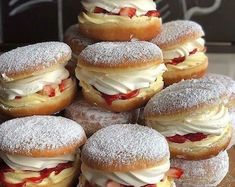 a pile of doughnuts sitting on top of a wooden table