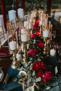 a long table with candles and flowers on it is set up for a formal dinner