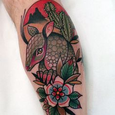 an arm with a tattoo design on it and flowers around the arm, in front of a white background