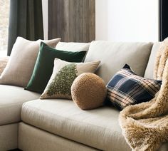 a couch with pillows and blankets on it