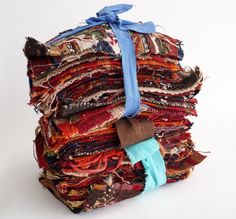 a stack of cloths with a blue ribbon tied around it