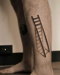 a man's leg with a ladder tattoo on it