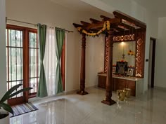 a living room with a large mirror and wooden pillars