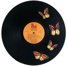 a black record with orange butterflies on it