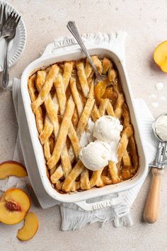 a white dish filled with ice cream next to sliced peaches