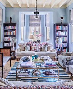 a living room filled with furniture and bookshelves