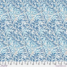 a blue and white pattern with leaves on it's side, as well as a ruler