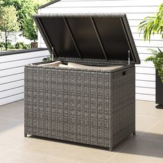 an outdoor storage box with lid open on the patio