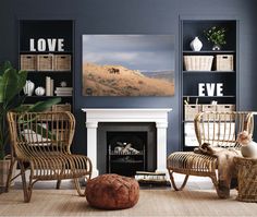 a living room filled with furniture and a fire place in front of a painting on the wall