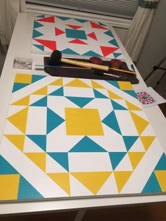 the table is covered with different colored geometric designs