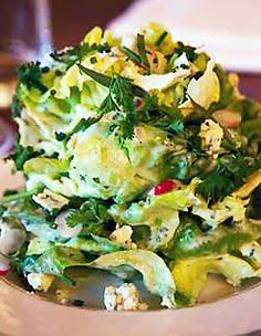 a white bowl filled with salad on top of a table