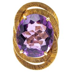 18k yellow gold ring. This eye-catching vintage ring has an oval faceted, medium to dark purple color amethyst, approximately 7.60 CTS and prong set into a bypass style shank, and decorated with a triple frame of flat, tooled wide rings. Marks: 750 Dimensions: 9/16" across the top x 7/8" long Weight: 5.3 gross dwt Ring Size: 6.75 Dark Purple Color, Triple Ring, Wide Rings, 18k Yellow Gold Ring, Yellow Gold Ring, Vintage Ring, Amethyst Ring, Yellow Gold Rings, Dark Purple