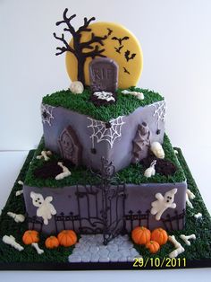 a three tiered cake decorated with halloween decorations