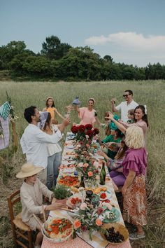 a group of people sitting around a long table