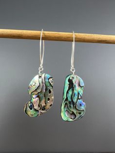 "A beautiful rainbow of color in this pair of Abalone shell earrings. Very lightweight and easy to wear all day.  Measure approx 2 1/4\" long Ear wires and findings are sterling silver.  Abalone jewelry is made using natural shell. I do not clear coat them. They are polished with natural food grade oil only. This pair is naturally shaped by the ocean." Multicolor Dangle Pearl Earrings For Pierced Ears, Multicolor Dangle Pearl Earrings, Unique Iridescent Pierced Earrings, Unique Iridescent Earrings, Unique Nickel-free Shell-shaped Earrings, Unique Silver Shell Earrings, Nickel Free Iridescent Mother Of Pearl Earrings, Nickel-free Iridescent Mother Of Pearl Earrings, Iridescent Nickel-free Mother Of Pearl Earrings