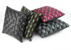 three black and pink pillows sitting on top of each other